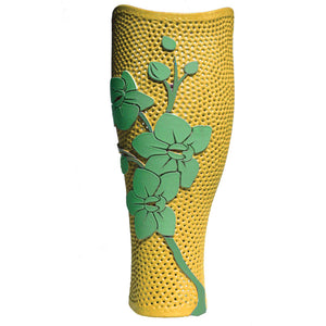 Yellow prosthetic cover with green flowers.