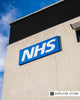 NHS building with clear blue NHS sign, symbolizing UK healthcare system and relevance to smart prosthetic technology adoption.