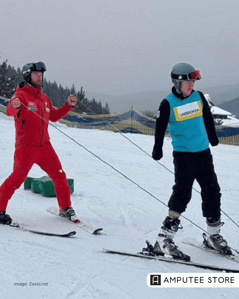 Ukrainian veteran with limb loss skiing with assistance, demonstrating adaptive skiing, rehabilitation, and return to sport after amputation.