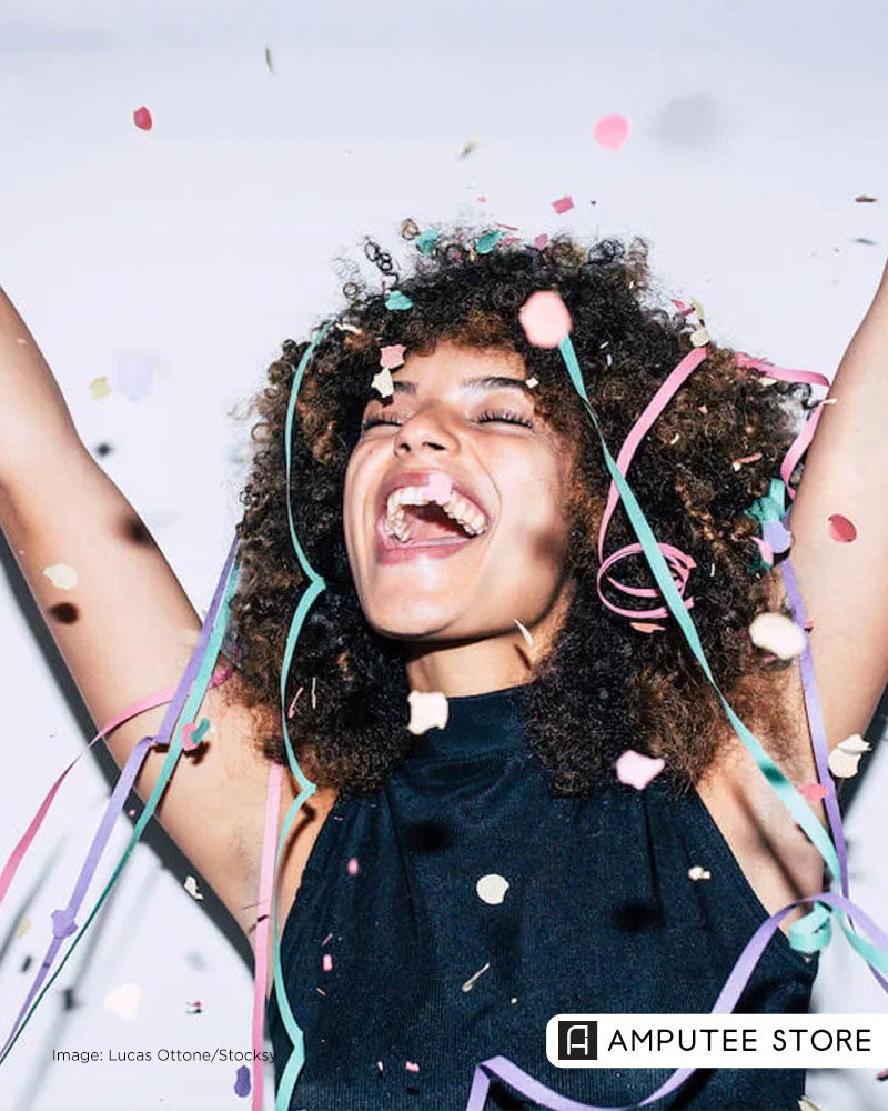 Smiling woman celebrating with confetti, symbolizing resetting health, space, and personal goals in the new year. 
