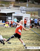 Amputee athlete with a prosthetic leg competing in a javelin throw during an adaptive sports event. 