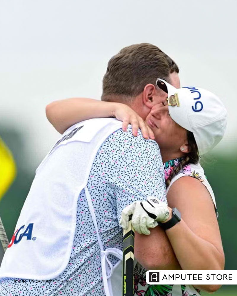 Amputee golfer embraces her partner and caddie on the golf course in a story about limb loss, adaptive golf, and love.