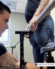 Salisbury VA prosthetics clinician assists a veteran during a lower-limb prosthetic fitting, illustrating personalized prosthetic care and follow-up support for veterans with limb loss.
