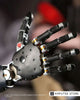 Close-up of an advanced robotic prosthetic hand illustrating research into kinesthesia, brain movement perception, and natural-feeling upper-limb prostheses.