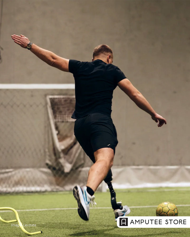 Person with a below-knee prosthesis plays soccer using Levitate prosthetic feet, highlighting adaptive sports, active lifestyle, and mobility after limb loss.