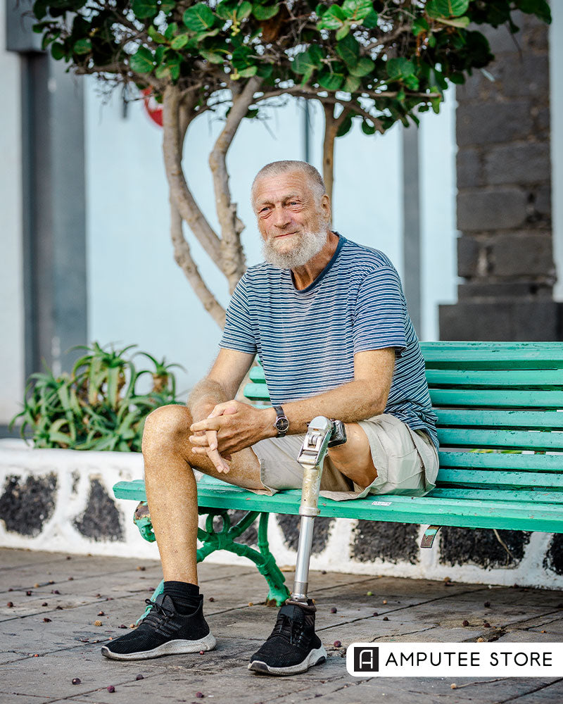 Medicare AI coverage pilot article image showing an older man with a below-knee prosthetic leg seated outdoors on a bench.