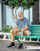 Medicare AI coverage pilot article image showing an older man with a below-knee prosthetic leg seated outdoors on a bench.