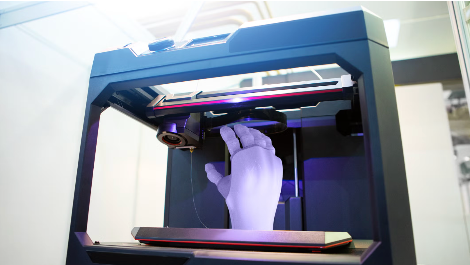 A 3D printer creating a child-sized prosthetic hand, illustrating how a Pakistani startup is using 3D printing technology to produce prosthetic limbs for child survivors injured in Gaza.