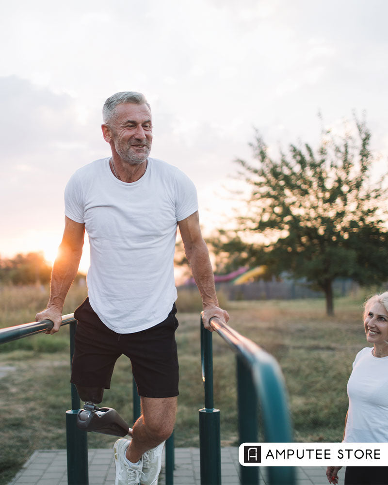Man with a below-knee prosthetic leg exercising outdoors on parallel bars, representing prosthesis care, mobility, and daily routines for skin and device health.