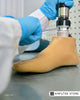 Technician adjusting a prosthetic foot, representing routine prosthetic care and maintenance tips.