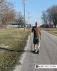 Double amputee Tom Jalinski walks with a prosthetic leg and hiking stick on a rural road to prepare for his 1,200-mile trek across Wisconsin to raise awareness for the challenges amputees face.