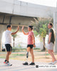 Woman with a below-knee prosthetic leg high-fiving a friend during an outdoor walk, representing healthy ways to manage stress and emotional wellness in the limb loss community.