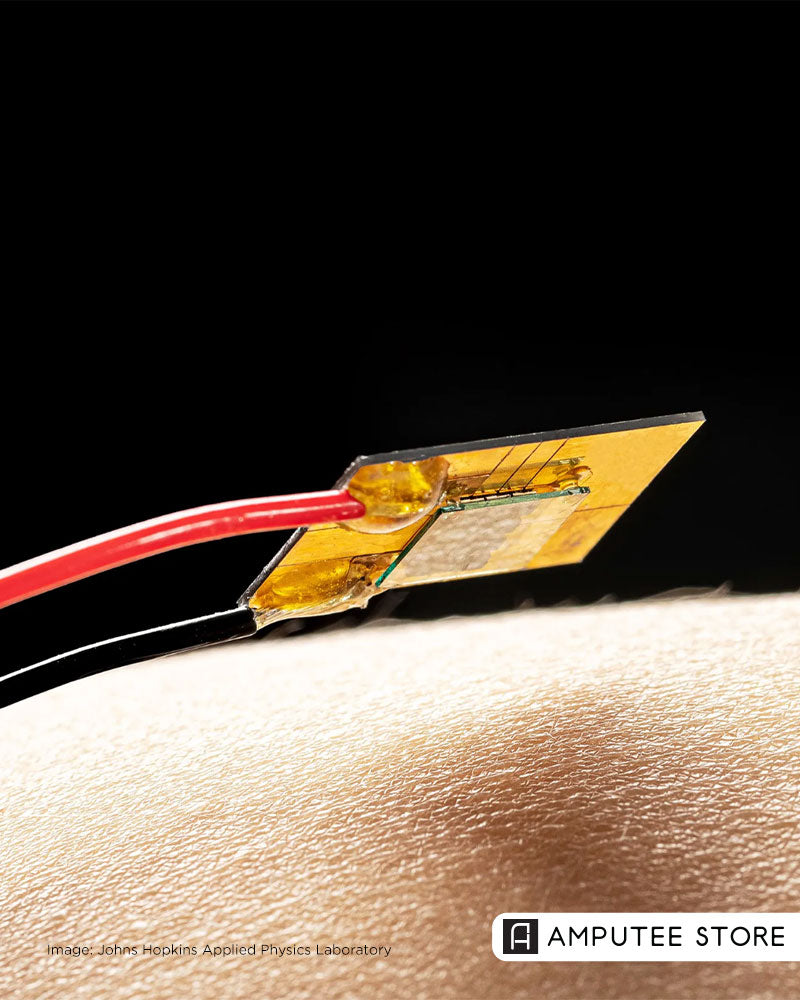 Close-up of a gold thermoelectric patch on human skin, illustrating new prosthetic technology that allows bionic limbs to feel temperature.