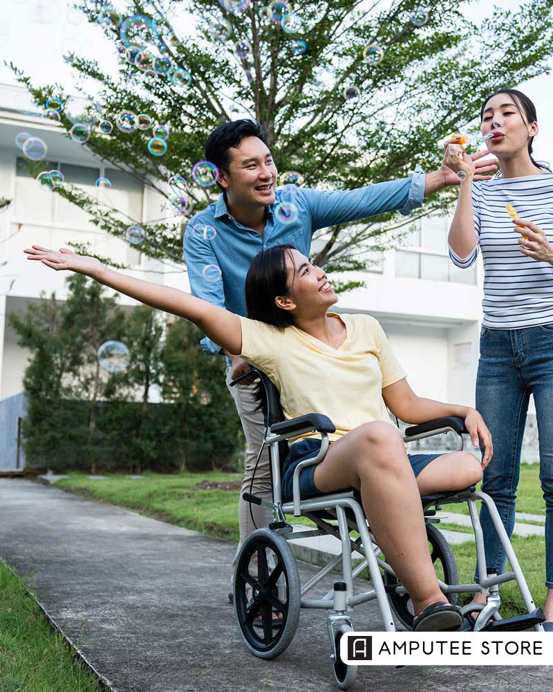 A woman in a wheelchair enjoying time outdoors with friends, illustrating lifestyle and health awareness about residual limb skin care for amputees.