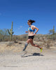 Woman with a running prosthetic leg on a desert trail, illustrating why amputees are more prone to chafing and skin irritation.